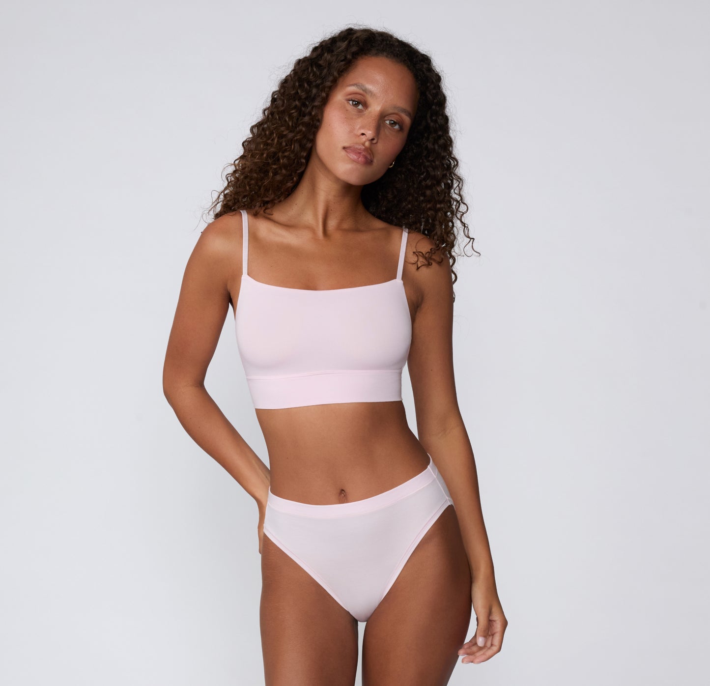 On a clean studio backdrop, a full-body view shows a model wearing the Cloud Cotton French Cut Brief in Primrose with the matching Cloud Cotton Thin Strap Bralette, highlighting the smooth waistband and French-cut silhouette.