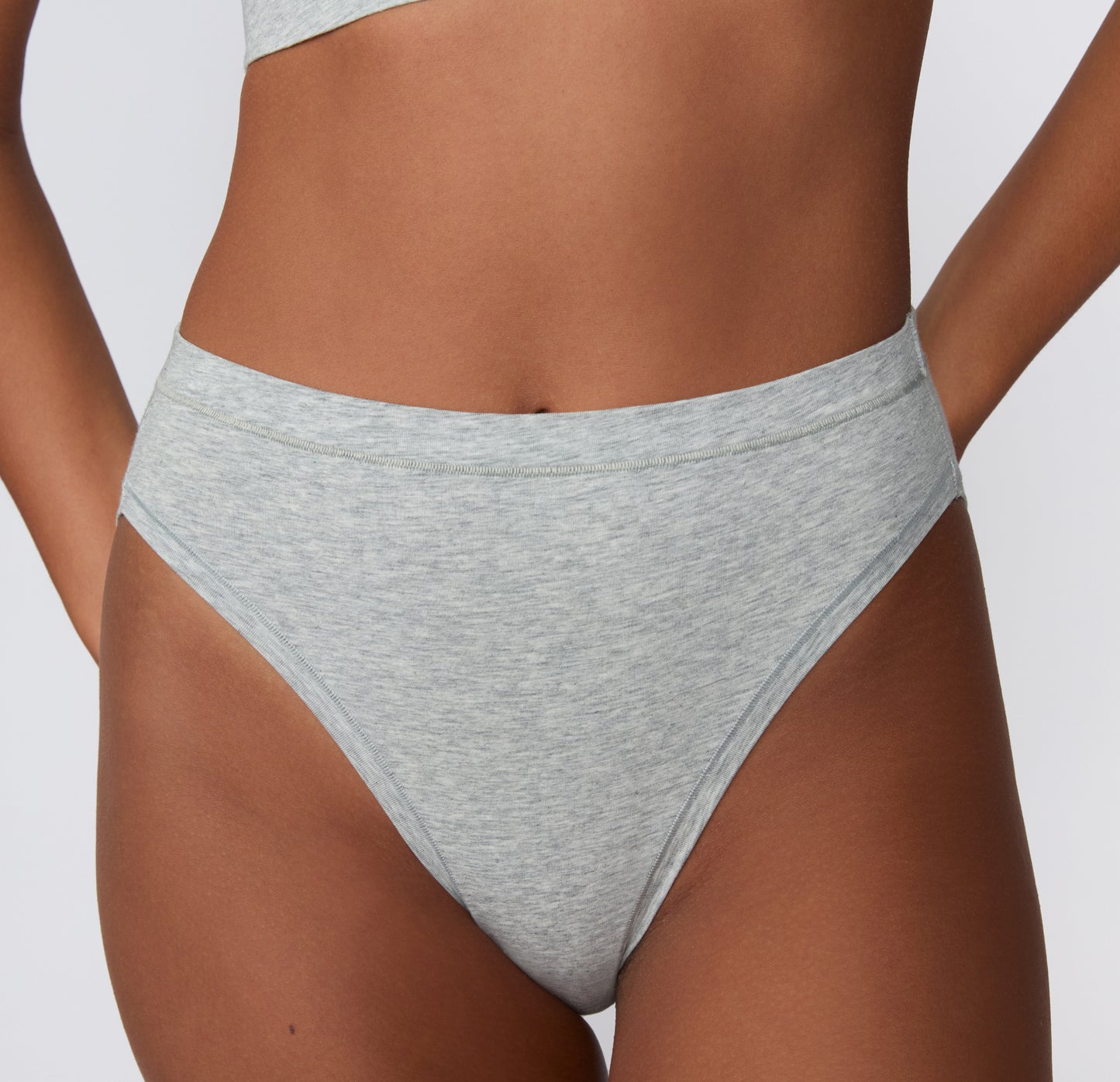 Front view on a light studio backdrop of the Cloud Cotton French Cut in Light Heather Grey, highlighting the high-cut leg opening and smooth waistband.