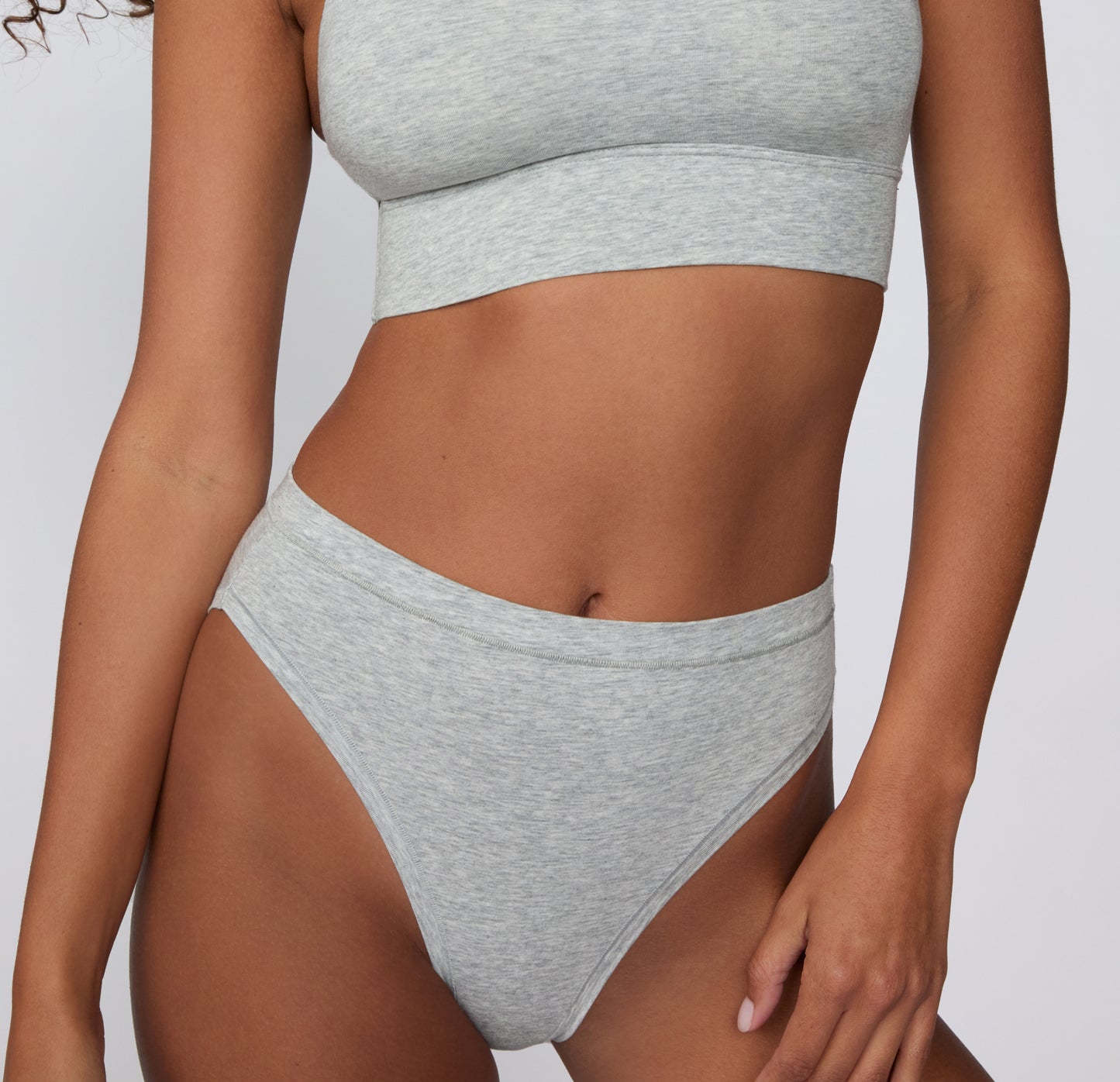 Close-up front view on a light studio backdrop of the Cloud Cotton French Cut in Light Heather Grey, focusing on the smooth waistband and soft fabric texture.