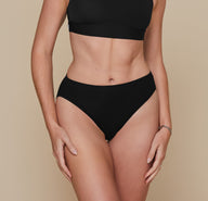 Front view of model wearing Cloud Cotton French Cut Brief in Black. The high leg and mid-rise waistband are emphasized.