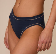 Close-up side view of the Cloud Cotton French Cut Brief in Midnight, worn by Marcela. The image focuses on the flattering curve of the high leg seam and soft, stretch cotton fit.