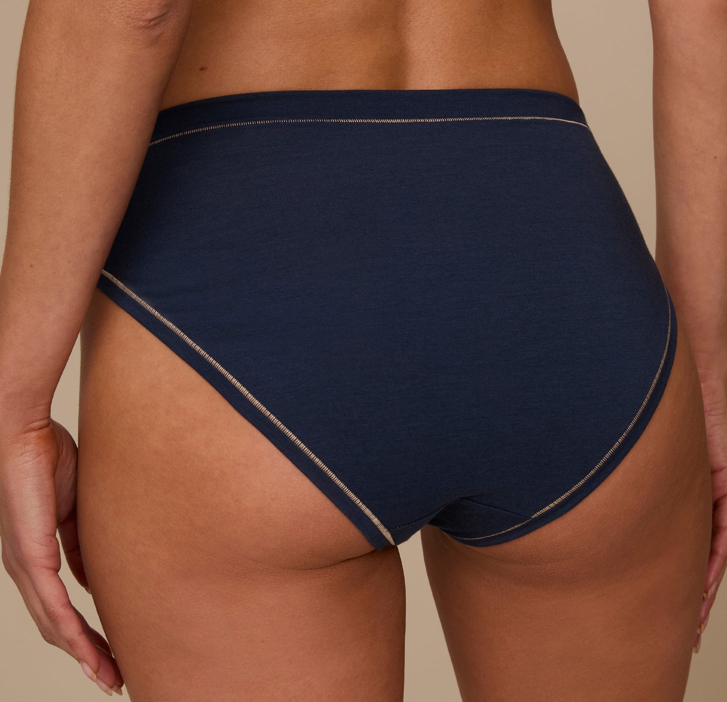 Rear view of Marcela wearing the Cloud Cotton French Cut Brief in Midnight. The photo showcases the brief’s mid-to-full back coverage and clean finish along the waist and leg openings.