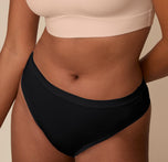 Close-up of the Cloud Cotton Highwaist Thong in Black on Victoria, focusing on the smooth, double-layer waistband and breathable, lightweight cotton fabric.