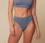 Front view of Megan in the Cloud Cotton Highwaist Thong in Slate. The high-rise waistband and soft V-front silhouette offer breathable coverage with a barely-there feel. sizing: Megan wears size Medium