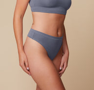 Side angle of Megan in the Cloud Cotton Highwaist Thong in Slate. The image highlights the gentle stretch and natural fit of the cotton-modal fabric along the hips and waist.