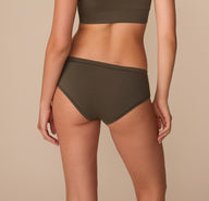 Back view of Alexis in the Cloud Cotton Hiphugger in Olive, highlighting moderate coverage and smooth waistband.