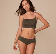 Full-body view of Alexis in the Cloud Cotton Hiphugger in Olive, styled with the matching Cloud Cotton Thin strap Bralette.