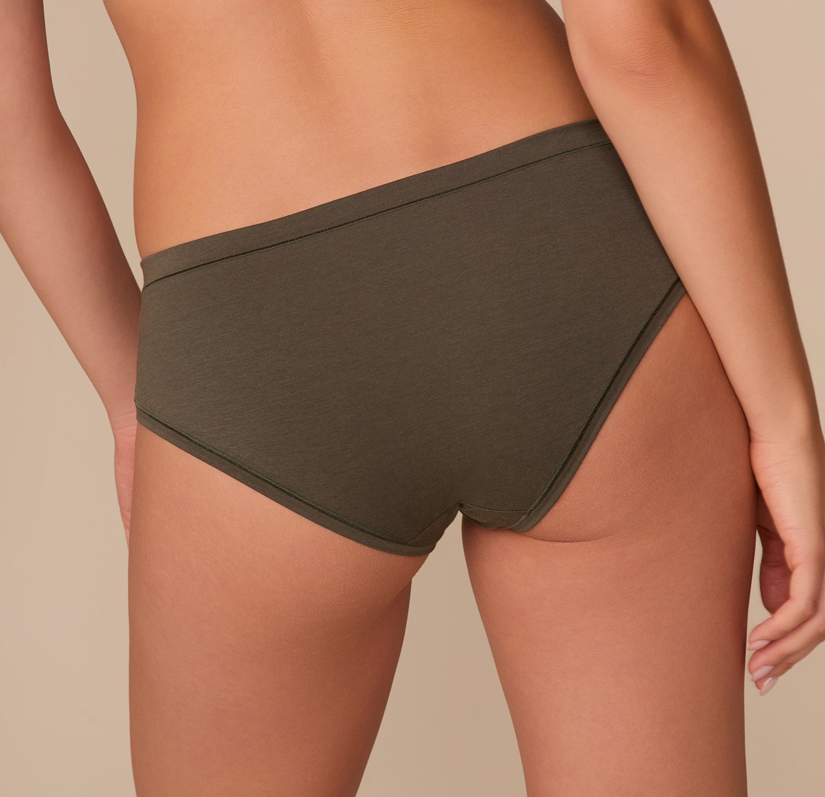 Close-up back angled view of Alexis in the Cloud Cotton Hiphugger in Olive, showcasing soft stretch cotton fabric.