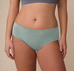 Close-up of the Cloud Cotton Hiphugger in Seaglass on model Sonnie. The image focuses on the mid-rise waistband and smooth front panel made from ultra-soft cotton modal fabric.