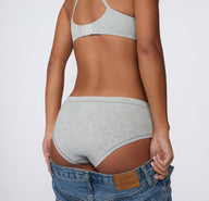 Back view on a light studio backdrop of the Cloud Cotton Hiphugger in Light Heather Grey, showing mid-rise coverage and a smooth, clean waistband.