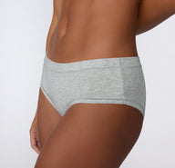 Angled side view on a light studio backdrop of the Cloud Cotton Hiphugger in Light Heather Grey, highlighting the hip-hugging fit and soft cotton modal fabric.