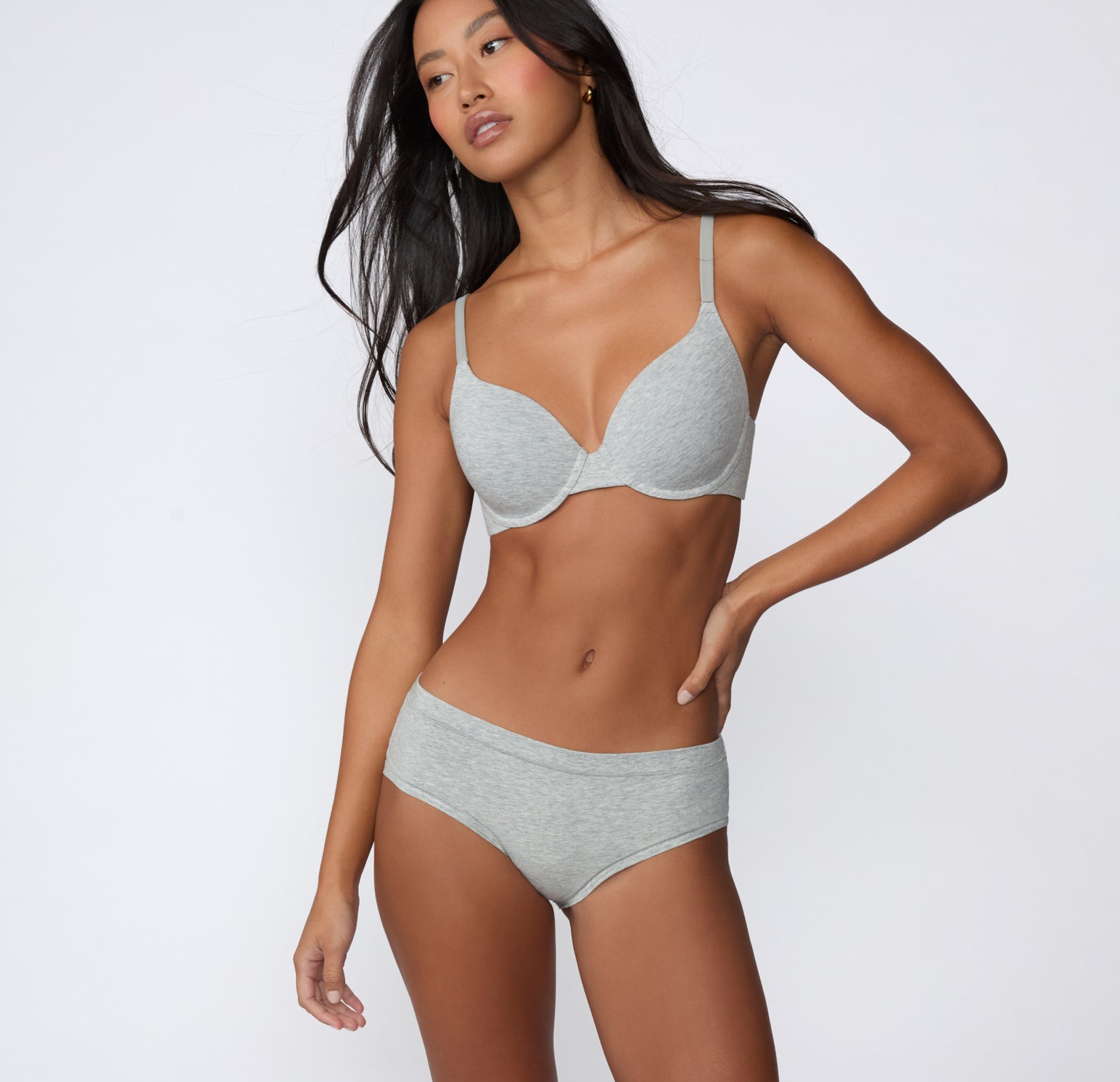 Full-body front view on a light studio backdrop of the Cloud Cotton Hiphugger in Light Heather Grey, paired with a Cloud Cotton bra for a coordinated set.