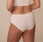 Back view of model Sonnie in the Cloud Cotton Hiphugger in Quartz. The image showcases full back coverage and a smooth, seamless look under clothing.