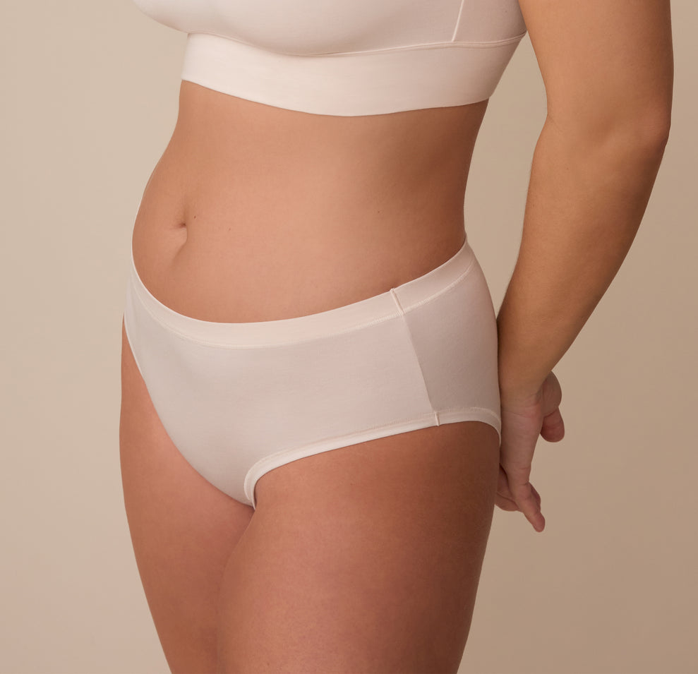 Side angle of model Sonnie wearing the Cloud Cotton Hiphugger in Quartz. This view emphasizes the smooth leg openings and minimal stitching.