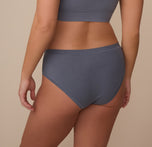 Three-quarter rear view of Sonnie modeling the Cloud Cotton Hiphugger in Slate. This view highlights the smooth, full back coverage and flat seams designed for all-day comfort.