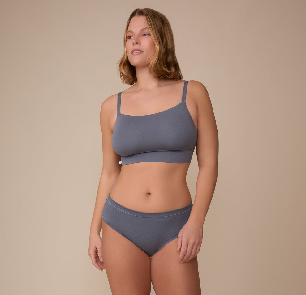 Full body shot of Sonnie in the Cloud Cotton Hiphugger and matching Cloud Cotton Thin Strap Bralette in Slate. She stands with relaxed posture, showcasing the clean, everyday look and cozy feel of the set.
