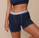 Angled front view of Sonnie wearing the Cloud Cotton Retro Boxer Brief in Midnight. The image highlights the contrast-stitched center seam and signature striped logo waistband. sizing: Sonnie wears size Large