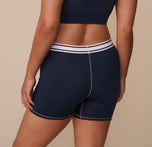 Rear view of Sonnie in the Cloud Cotton Retro Boxer Brief in Midnight. The smooth back panel and Harper Wilde logo waistband are visible, emphasizing full hip and rear coverage.