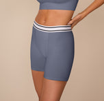 Side profile of model Freya in the Cloud Cotton Boxer Brief in Slate. The boxer brief sits at the waist with a supportive waistband and mid-thigh leg openings for a no-ride fit.