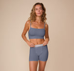 Model Freya stands in a relaxed pose wearing the Cloud Cotton Boxer Brief in Slate. The image captures the stretch waistband and soft, breathable design made for lounging or layering.