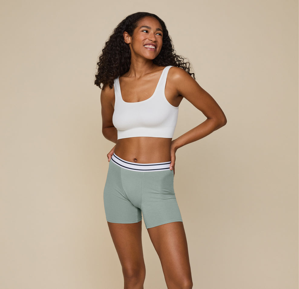 Front face view of Zoe wearing the Cloud Cotton Logo Boxer Brief in Seaglass.