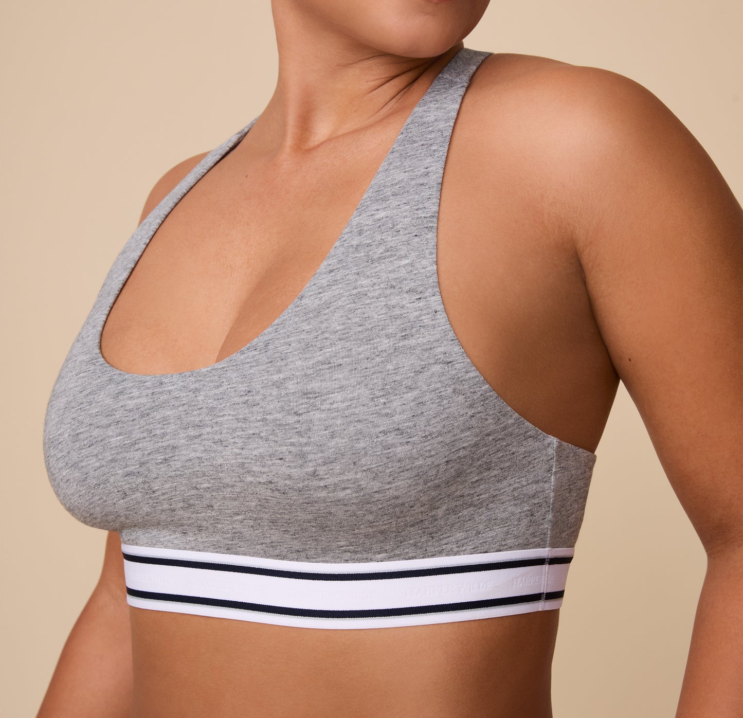 A detailed shot focusing on the soft, ribbed elastic underband of the Cloud Cotton Retro Racerback Bralette in Heather Charcoal. The comfortable, Cotton fabric and scoop neckline are emphasized.