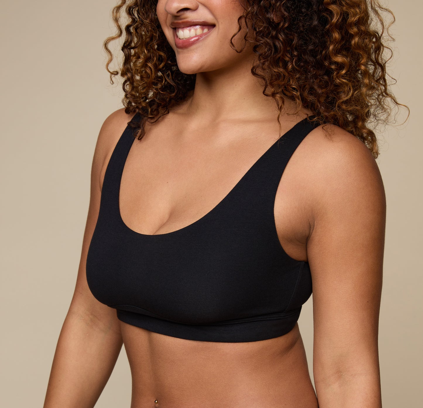 Close-up of Jade in the Cloud Cotton Scoop Bralette in Black, focusing on the neckline and supportive fit. The image captures the brushed cotton texture and clean finish.