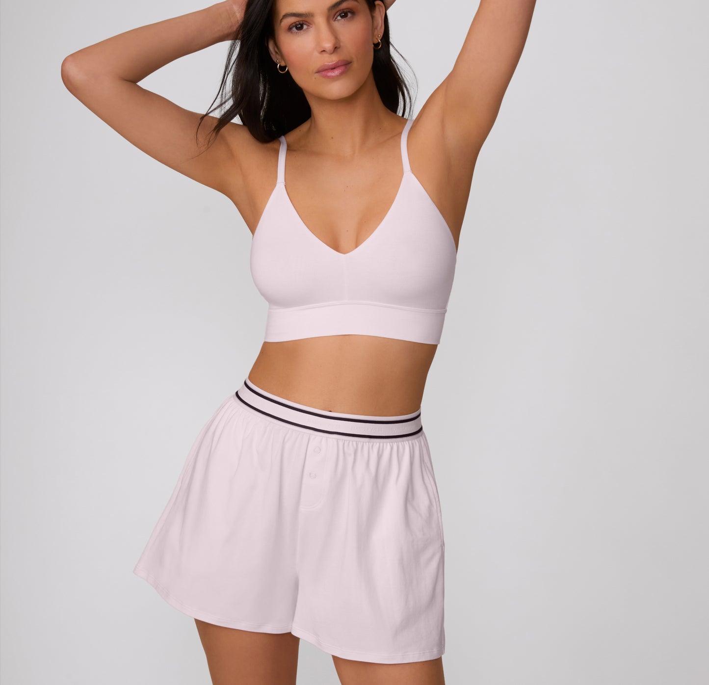 On a clean studio backdrop, a full-body view shows a model wearing the Cloud Cotton Short in Primrose styled with a matching Cloud Cotton bralette, highlighting the relaxed silhouette and lightweight fabric.