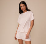 Full body shot of Marcela wearing the Cloud Cotton T-Shirt and matching short in Quartz. She stands in a relaxed pose, showcasing the full set’s casual, cozy fit.