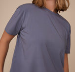 Close-up of the upper half of Sonnie wearing the Cloud Cotton T-Shirt in Slate. The image captures the softness of the cotton-modal fabric.