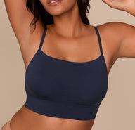 Close-up of Victoria wearing the Cloud Cotton Thin Strap Bralette in Midnight, focusing on the neckline and front panel to show the soft cotton-modal fabric and longline silhouette.
