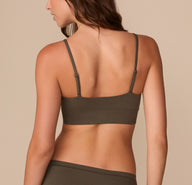 Back view of Alexis in the Cloud Cotton Thin Strap Bralette in Olive, highlighting the smooth band and thin straps.
