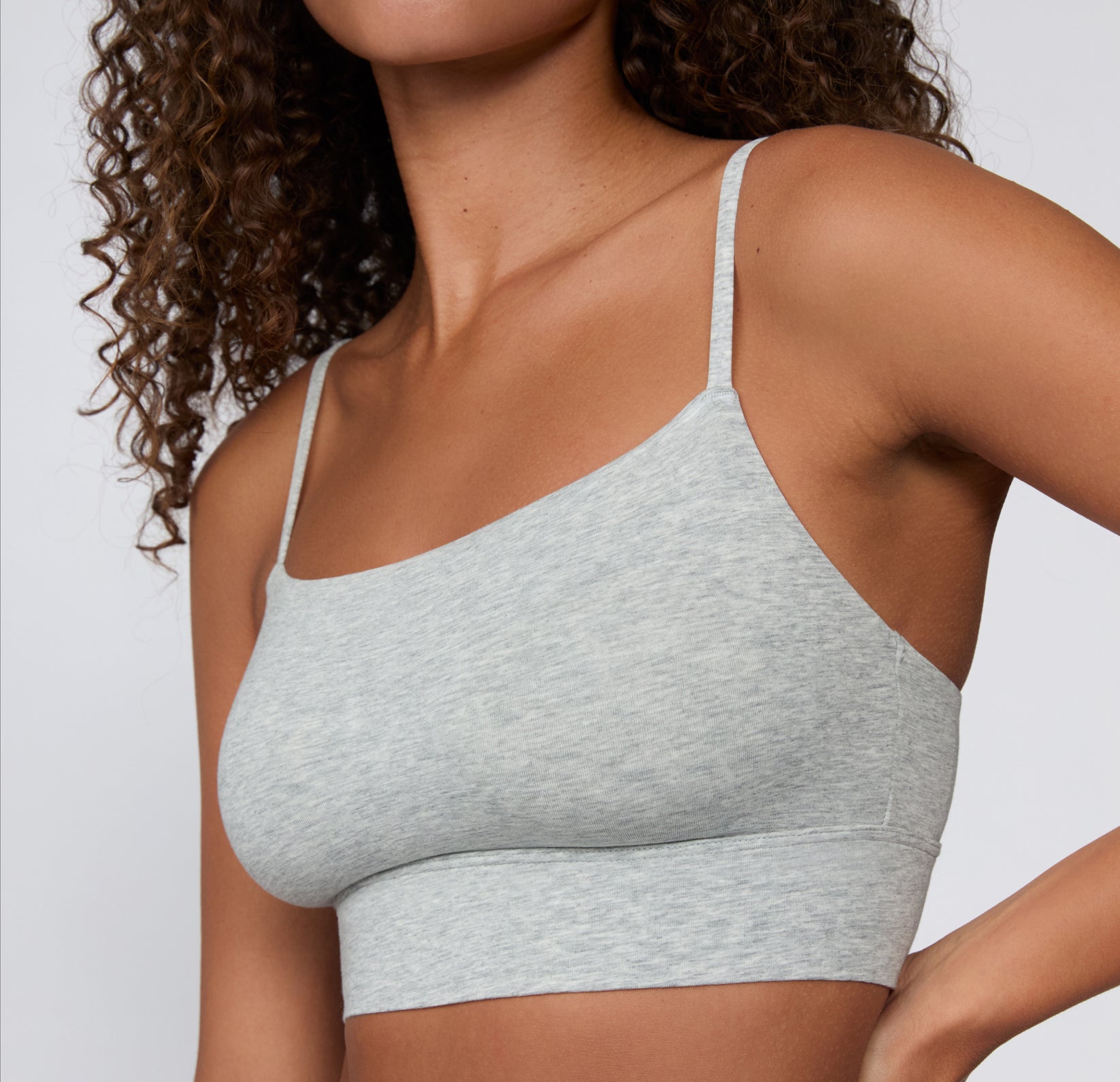Close-up on a light studio backdrop of the Cloud Cotton Thin Strap Bralette in Light Heather Grey, focusing on the square neckline, soft fabric texture, and slim adjustable straps.