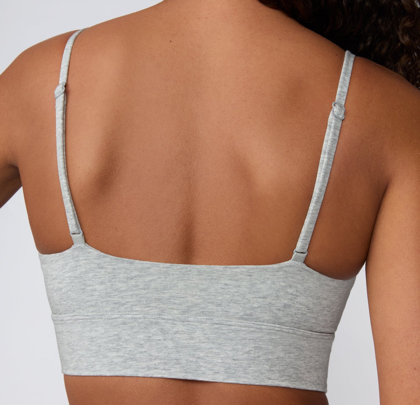 Back view on a light studio backdrop of the Cloud Cotton Thin Strap Bralette in Light Heather Grey, showing the straight back band and back-adjusting thin straps.