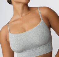 Close-up on a light studio backdrop of the Cloud Cotton Thin Strap Bralette in Light Heather Grey, focusing on the square neckline, smooth fabric texture, and lightweight straps.