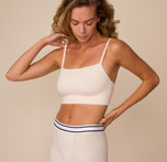 Three quarter angle of model Freya wearing the Cloud Cotton Thin Strap Bralette in Quartz. The image emphasizes the bralette’s minimal seams and second-skin comfort.
