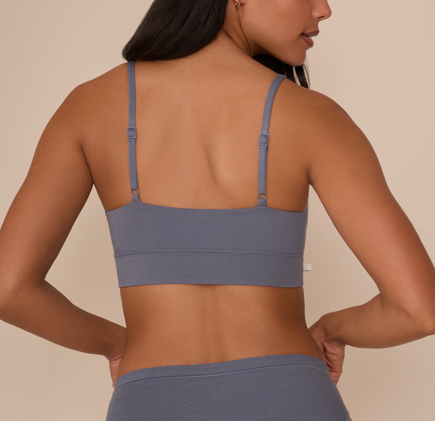 Back view of Nemesis in the Cloud Cotton Thin Strap Bralette in Slate, showcasing the wide back band and thin adjustable straps for customizable comfort.