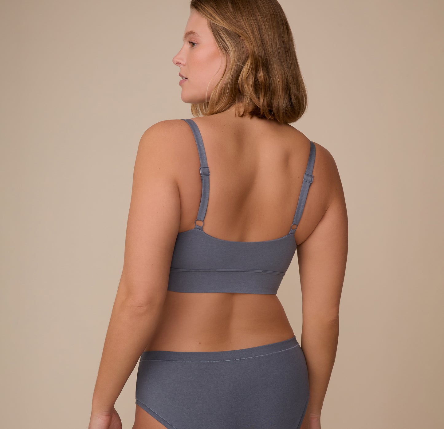 Back view of Sonnie in the Cloud Cotton Thin Strap Bralette in Slate, with minimal seams and adjustable straps that rest flat against the skin.