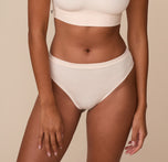 Front view of model Victoria wearing the Cloud Cotton Thong in Quartz. The image highlights the mid-rise waistband and soft, breathable cotton fabric for everyday comfort. sizing: Victoria wears size Medium
