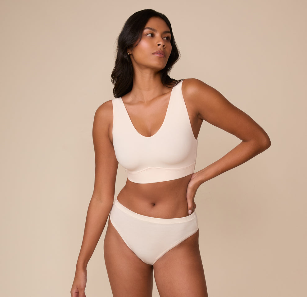 Full-body view of model Victoria in the Cloud Cotton Thong and matching Bliss Bralette in Quartz. The image presents the coordinated set with a clean, modern aesthetic.