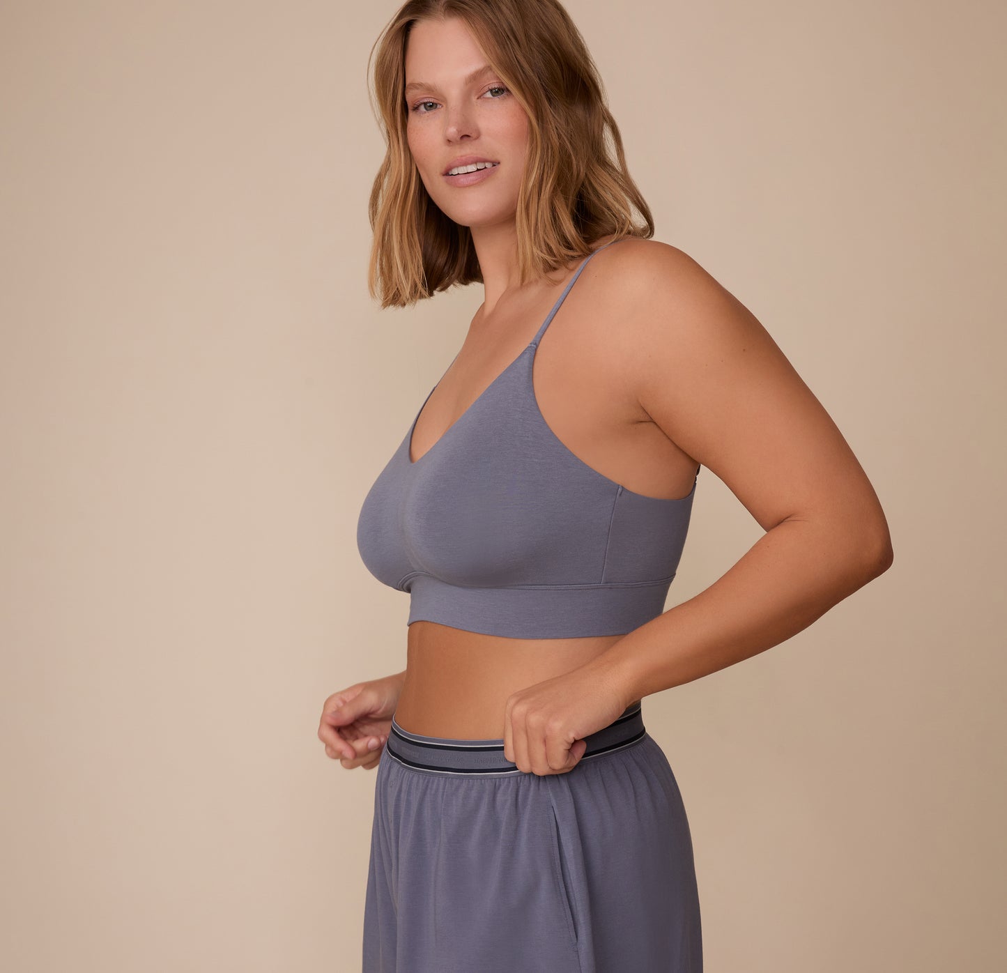 Sonnie wearing the Cloud Cotton Triangle Bralette and Cloud Cotton Pajama Shorts in Slate. The image highlights the soft triangle shape and smooth cotton finish. sizing: Sonnie wears size XL
