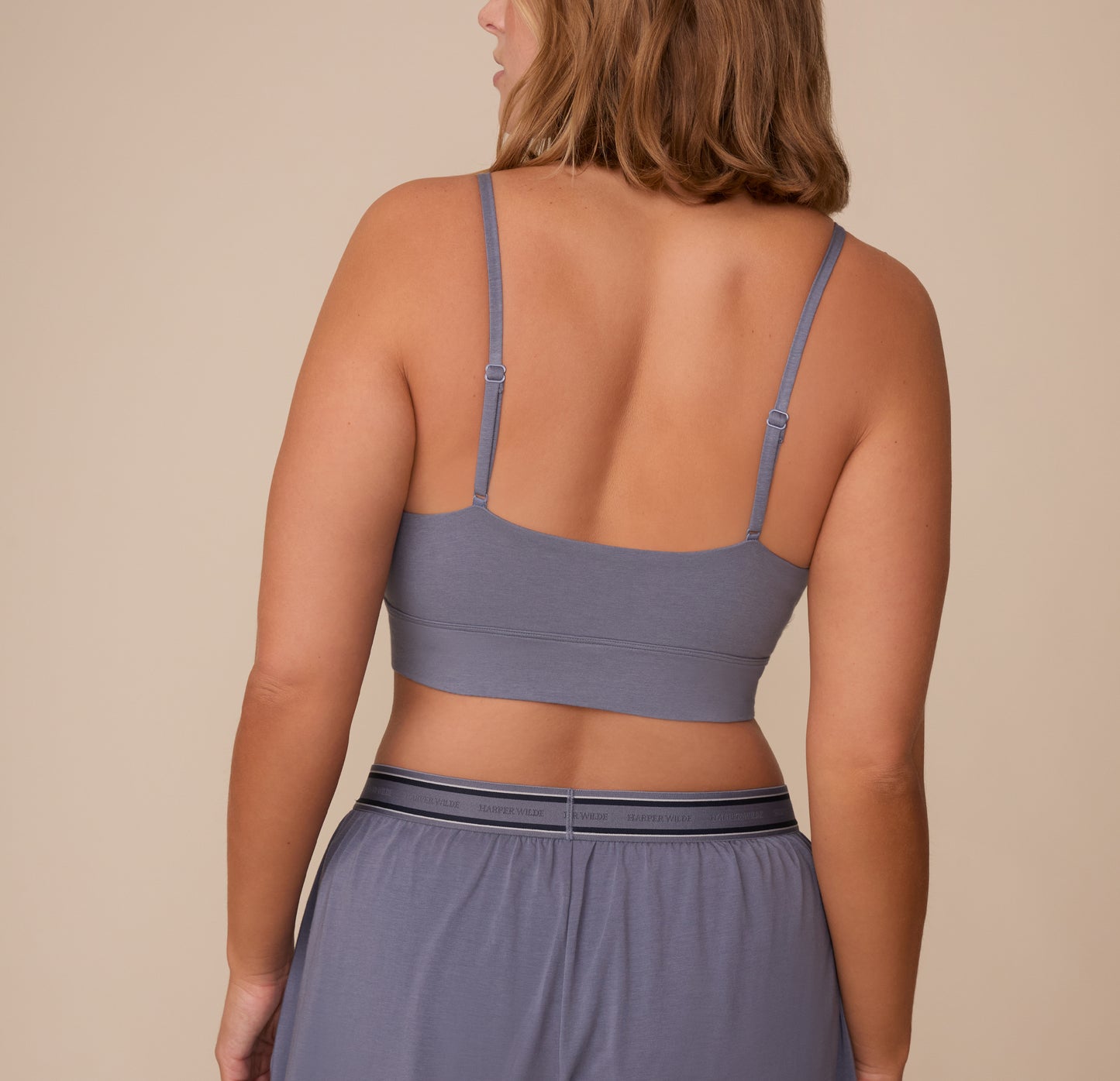 Back view of Sonnie wearing the Cloud Cotton Triangle Bralette in Slate. The image highlights the adjustable straps and wide underband for a comfortable fit.