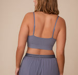 Back view of Sonnie wearing the Cloud Cotton Triangle Bralette in Slate. The image highlights the adjustable straps and wide underband for a comfortable fit.