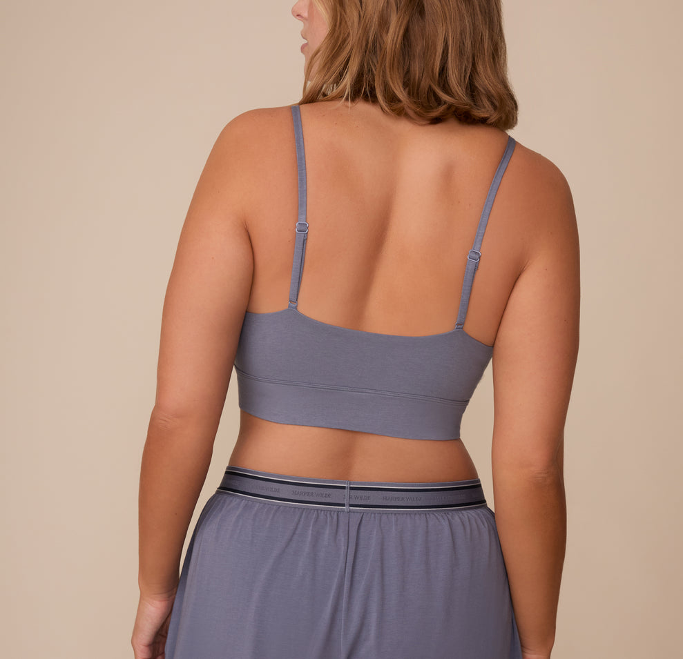 Back view of Sonnie wearing the Cloud Cotton Triangle Bralette in Slate. The image highlights the adjustable straps and wide underband for a comfortable fit.