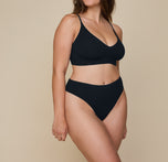 Detailed close-up of Summerlyn wearing the Cloud Cotton Highwaist Thong in Black, focusing on the soft fabric. sizing: Summerlyn wears size Large
