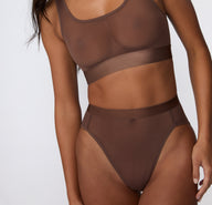 On a white studio backdrop, a close-up view shows the ComfortMesh™ Highwaist in Cashmere worn with the matching bralette, highlighting the sheer mesh fabric, smooth waistband, and high-rise coverage.