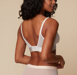 Back view of the model in the ComfortMesh Triangle Bralette in Delicate. The image highlights the adjustable shoulder straps and wide band for a smooth, secure fit.