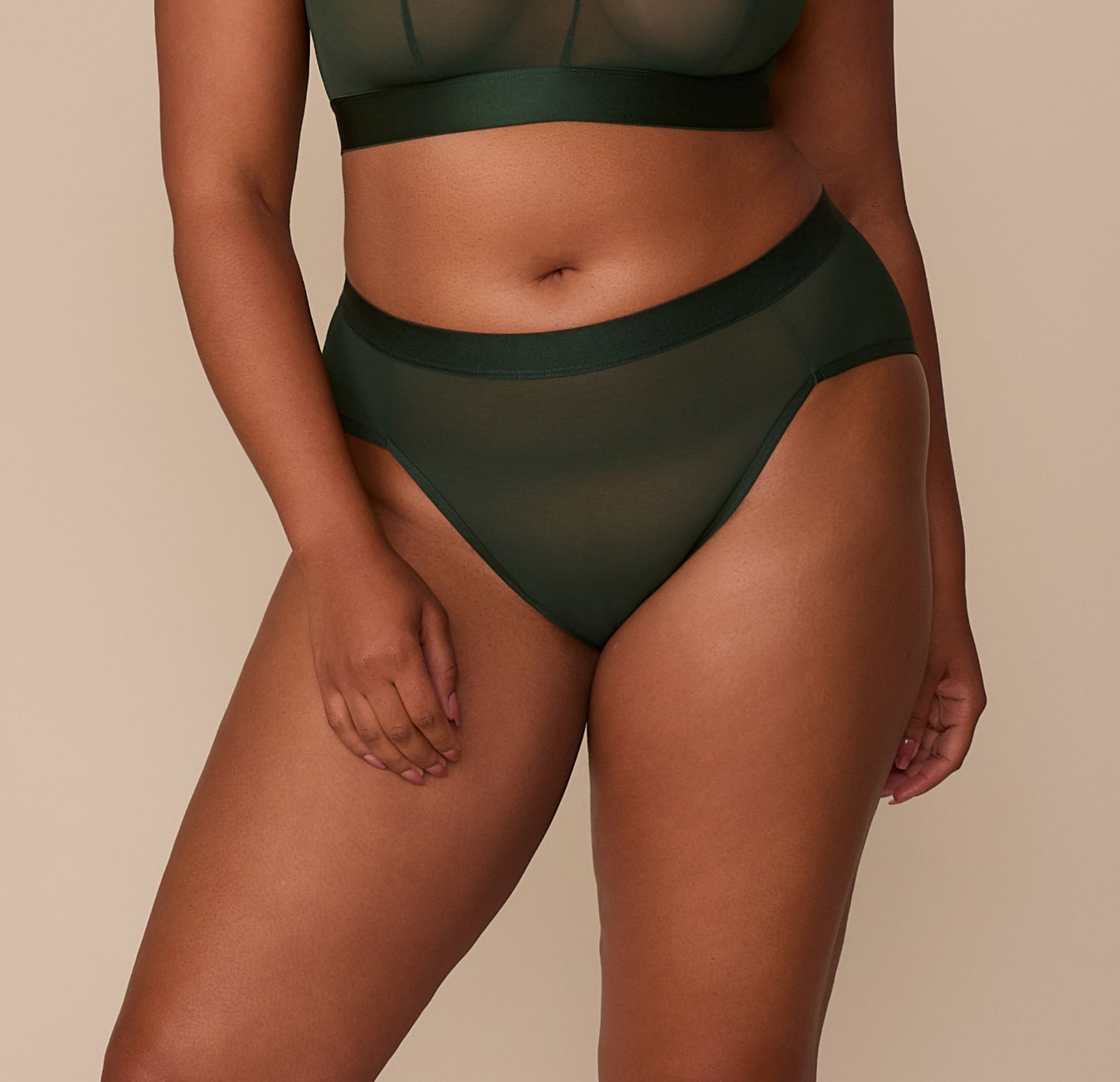 Front view of Zarria wearing the ComfortMesh™ Highwaist Brief in Sequoia. The sheer mesh fabric and high-rise waistband provide a smooth, breathable fit. sizing: Zarria wears sizes XL