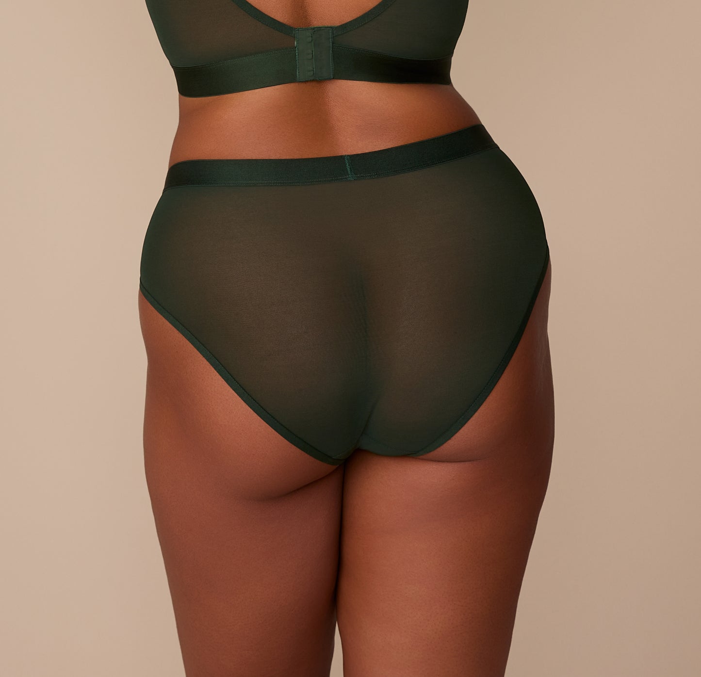 Back view of Zarria wearing the ComfortMesh™ Highwaist Brief in Sequoia, showing the high leg opening and moderate back coverage of the soft, stretchy mesh.