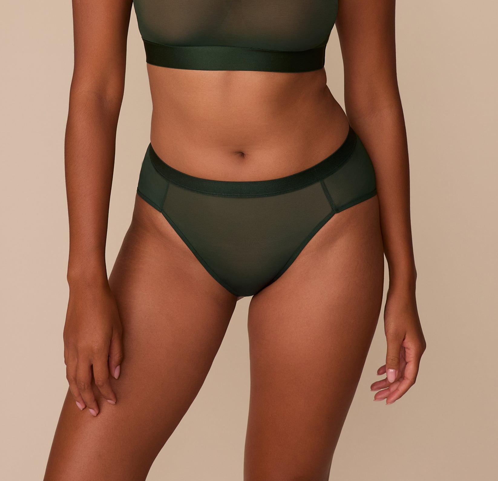 Front view of Victoria wearing the ComfortMesh™ Highwaist Brief in Sequoia, highlighting the supportive waistband and smooth sheer coverage across the hips. sizing: Victoria wears size Medium